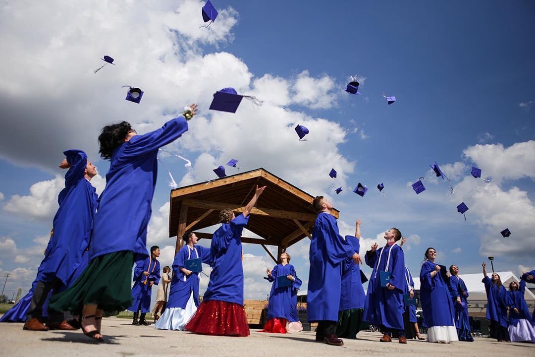 SCA Alumni Throwing Graduation Caps